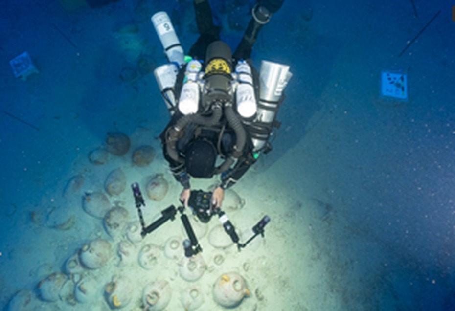 Diver photographing the Xlendi shipwreck at 110m depth